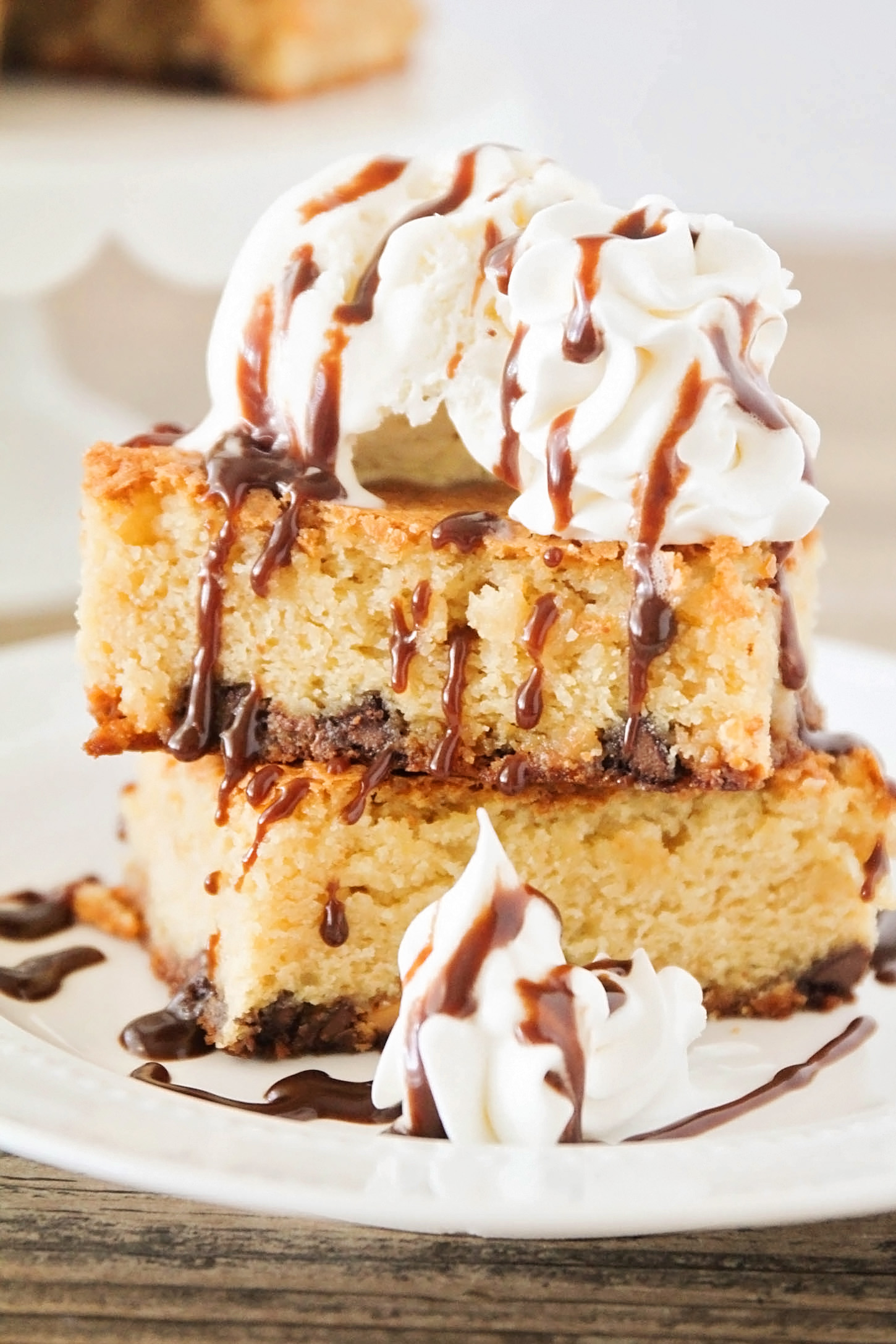 White chocolate blondies scattered with chunks of milk chocolate topped with ice-cream, homemade chocolate sauce and whipped cream!