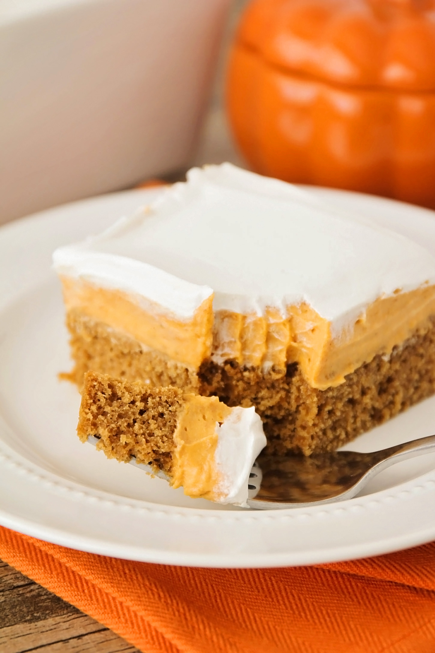 Delicious layers of soft gingerbread cake, creamy pumpkin filling and light whipped topping in an easy to make fall dessert.